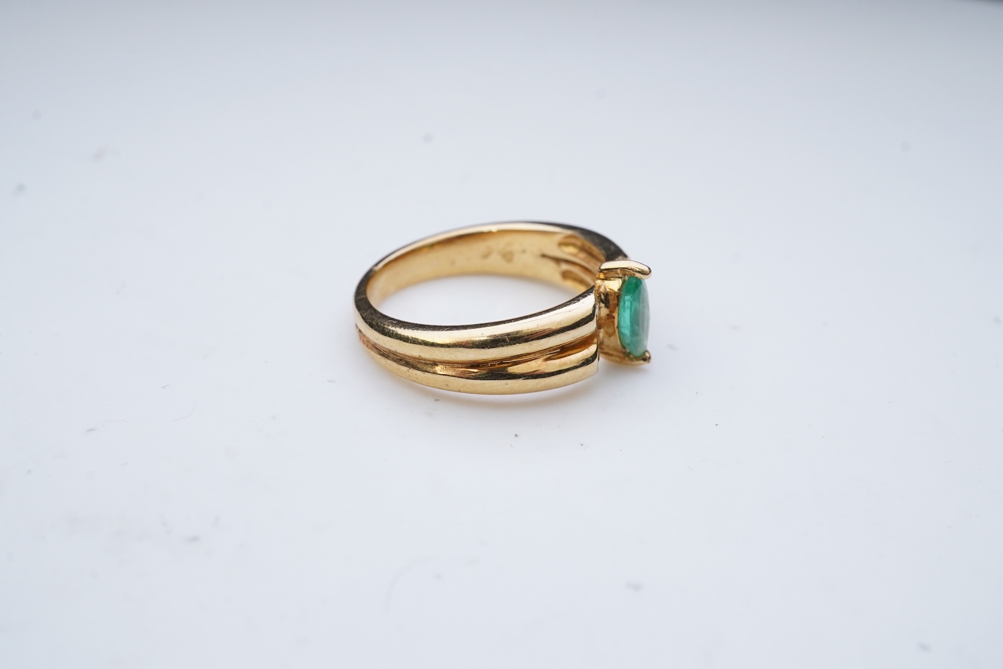 An emerald and diamond ring